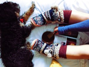 cozy slippers with dog and coffee
